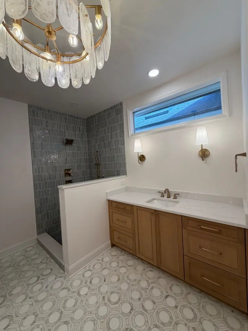 Finished bathroom remodel with tiled shower, custom vanity, and new lighting