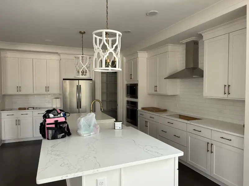 Finished kitchen remodel with quartz island and custom cabinetry by Elite Painting & Remodeling in Charlotte
